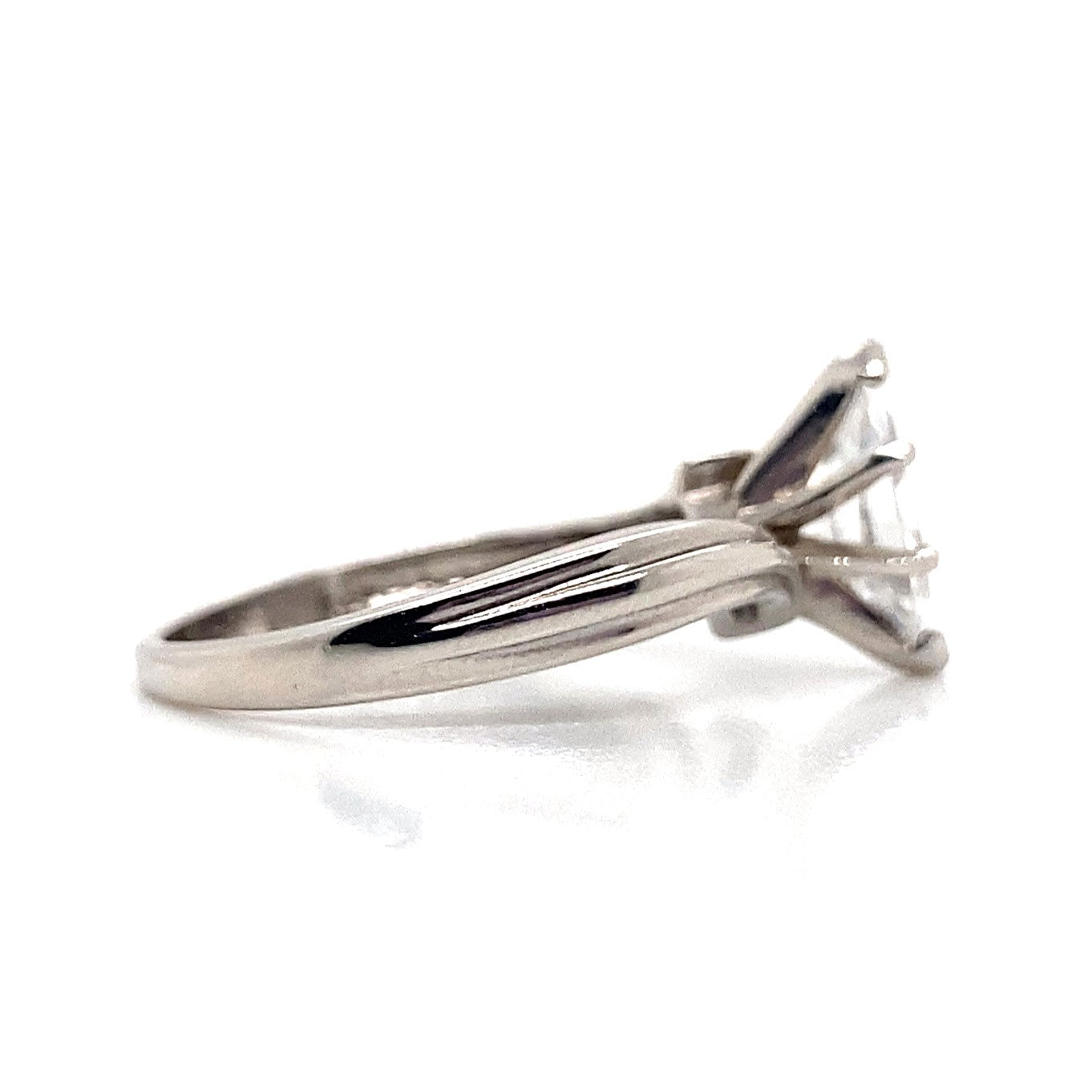 14K white gold ring featuring a marquise-cut solitaire cubic zirconia on a grooved bypass style band, beautifully displayed against a white background.