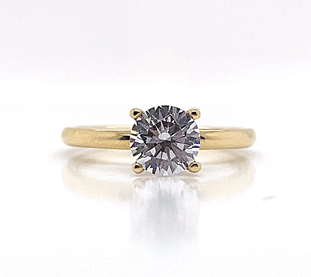 A stunning ring named "14K Yellow Gold CZ Center Solitaire Setting" showcases a brilliant cubic zirconia solitaire against a shiny white background.