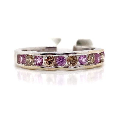 This elegant 14K white gold ring showcases a wavy band embellished with alternating natural pink sapphires and natural chocolate diamonds.