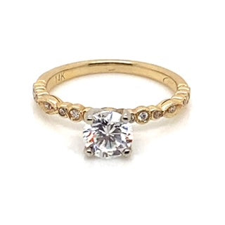 This exquisite Art Deco style ring showcases a .55 carat total weight natural round brilliant diamond centerpiece, beautifully accented by .10 carat of natural round brilliant diamonds along the 14K yellow gold band.