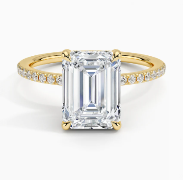 The 14K yellow gold ring showcases a 1.91 carat emerald-cut lab-grown diamond at its center, complemented by 1/5 carat total weight of lab-grown diamond accents on the band. This exquisite piece of sustainable jewelry offers timeless elegance with an eco-friendly touch.