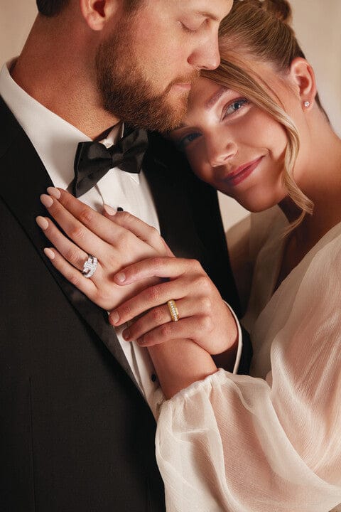 Man and woman in formal attire with close-up of hands showing rings in CHandler AZ.