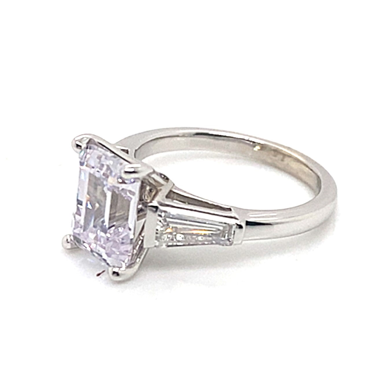 A 14K white gold engagement ring featuring a striking 9x7mm emerald-cut center cubic zirconia, complemented by .70 carat total weight natural baguette diamond accents with G/VS clarity.