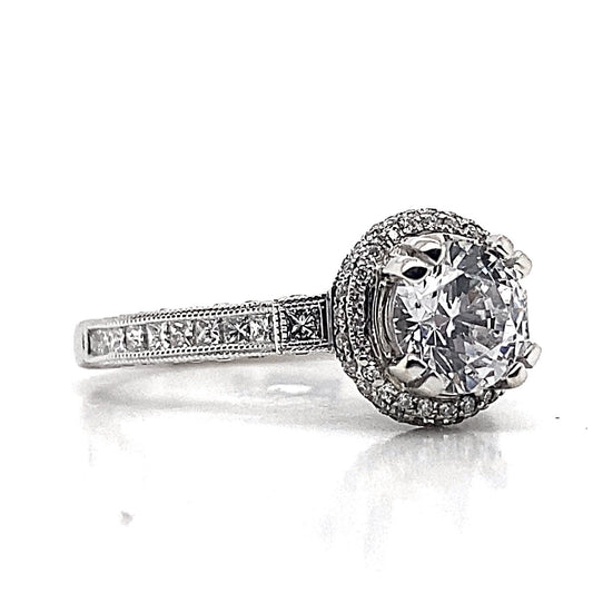 18K white gold engagement ring featuring a 6.5mm RBC CZ center stone, complemented by 1.08ct total weight of natural princess and round brilliant diamond accents along the band, offering a timeless proposal.