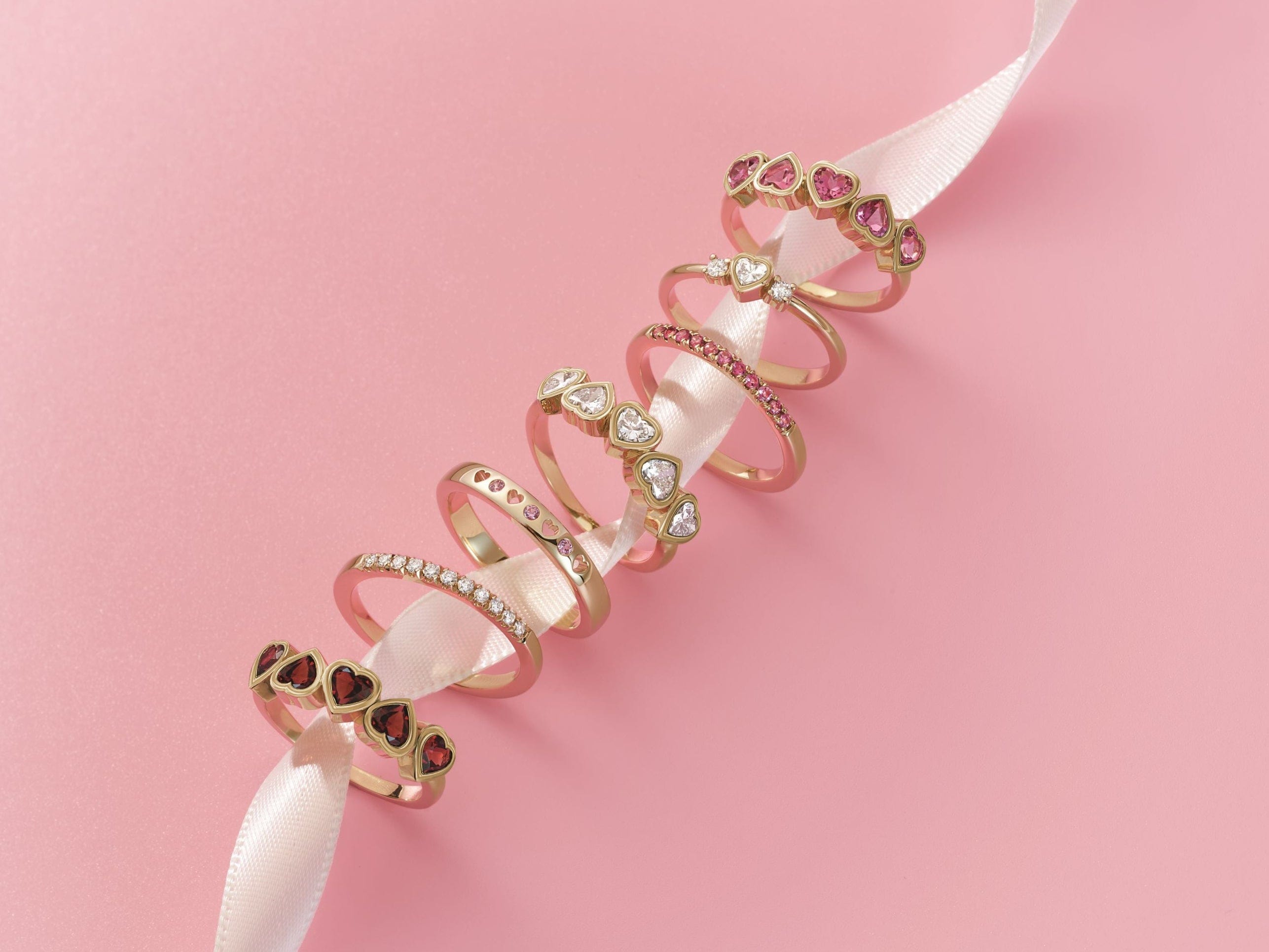 gemstone rings on a pink background
