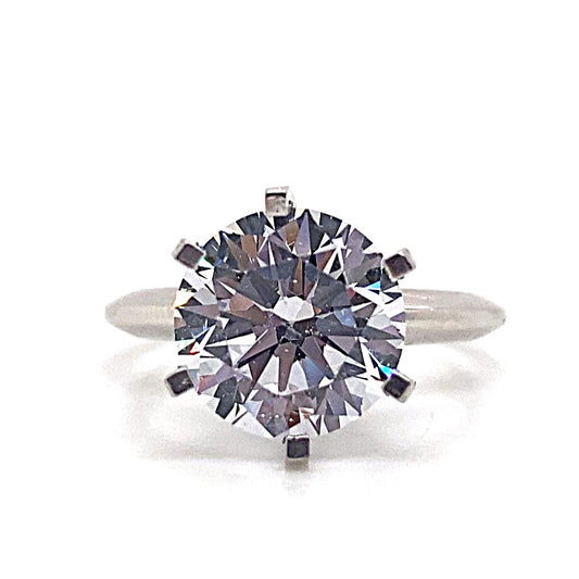 A 14K white gold ring featuring a prominent 9mm round brilliant cut CZ solitaire in a prong setting.