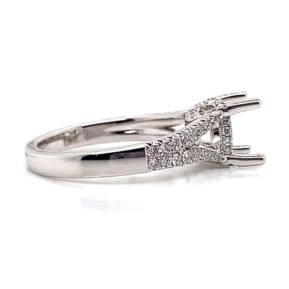 An 18K white gold split shank style ring, without a central gemstone (8 mm RBC), features .47 carat total weight of natural round brilliant diamond accents, making it an ideal choice for your customizable proposal.