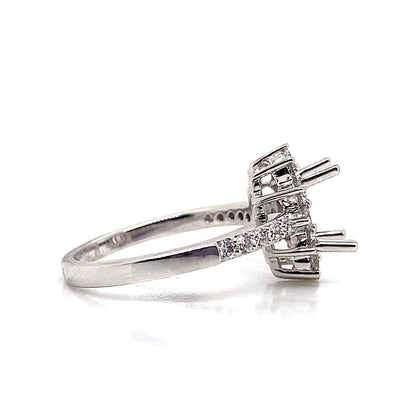 The 18K white gold ring, featuring a halo style with no center stone and .62 carat total weight of natural round brilliant diamond accents along the band, is displayed from the side against a white background.