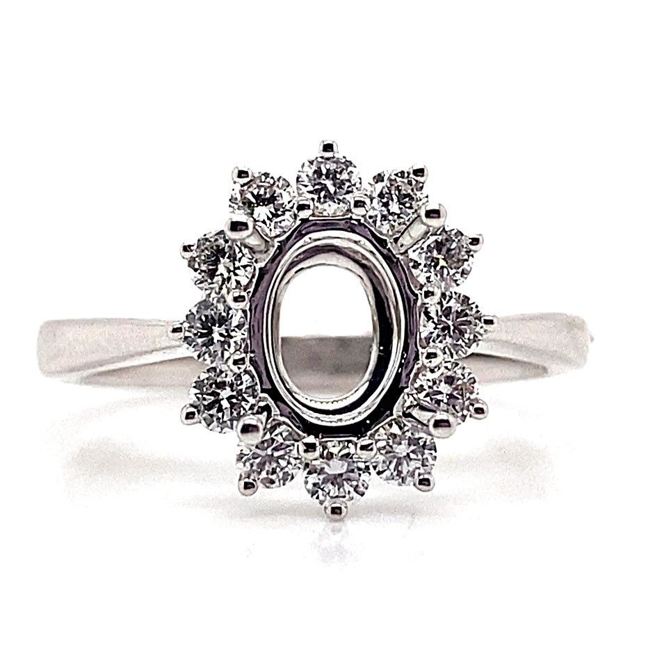 This 18K white gold ring boasts a beautiful, oval-shaped design accentuated by .51 carat total weight of natural round brilliant diamond accents in a halo style.