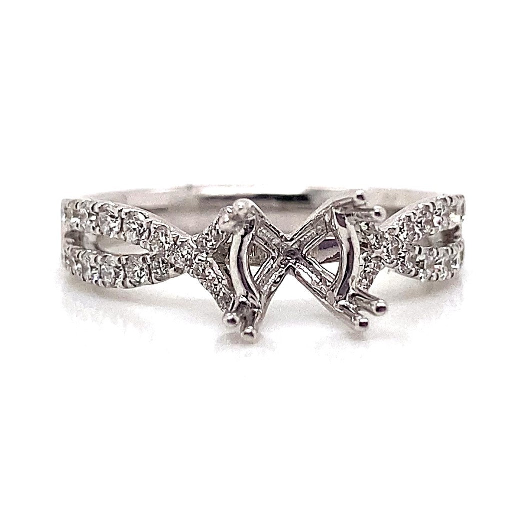 An exquisite 18K white gold infinity style ring featuring a crisscross design, intricately set with delicate natural round brilliant diamond accents totaling .39 carats.