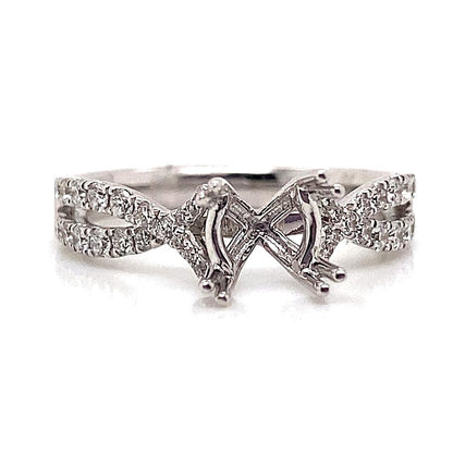 An exquisite 18K white gold infinity style ring featuring a crisscross design, intricately set with delicate natural round brilliant diamond accents totaling .39 carats.