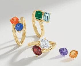 gemstone rings with colorful gemstones on a light gray background