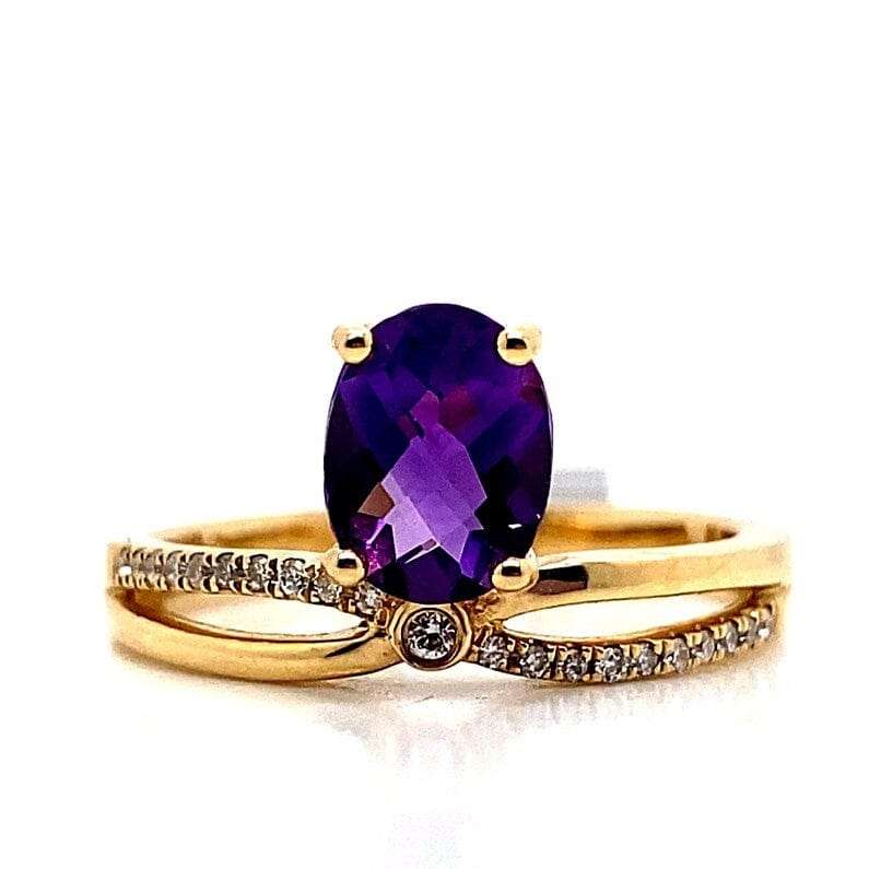 Gold ring with a large oval purple gemstone and diamond accents on the band.