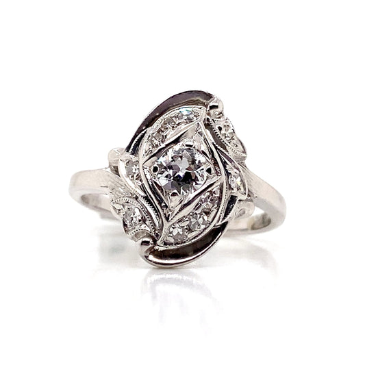 This exquisite ring is crafted from 14-karat white gold and showcases a central 0.25-carat European Cut Round Diamond (chipped center) with I1 clarity and H-I color, beautifully complemented by 0.45 carats total weight of natural diamond accents.