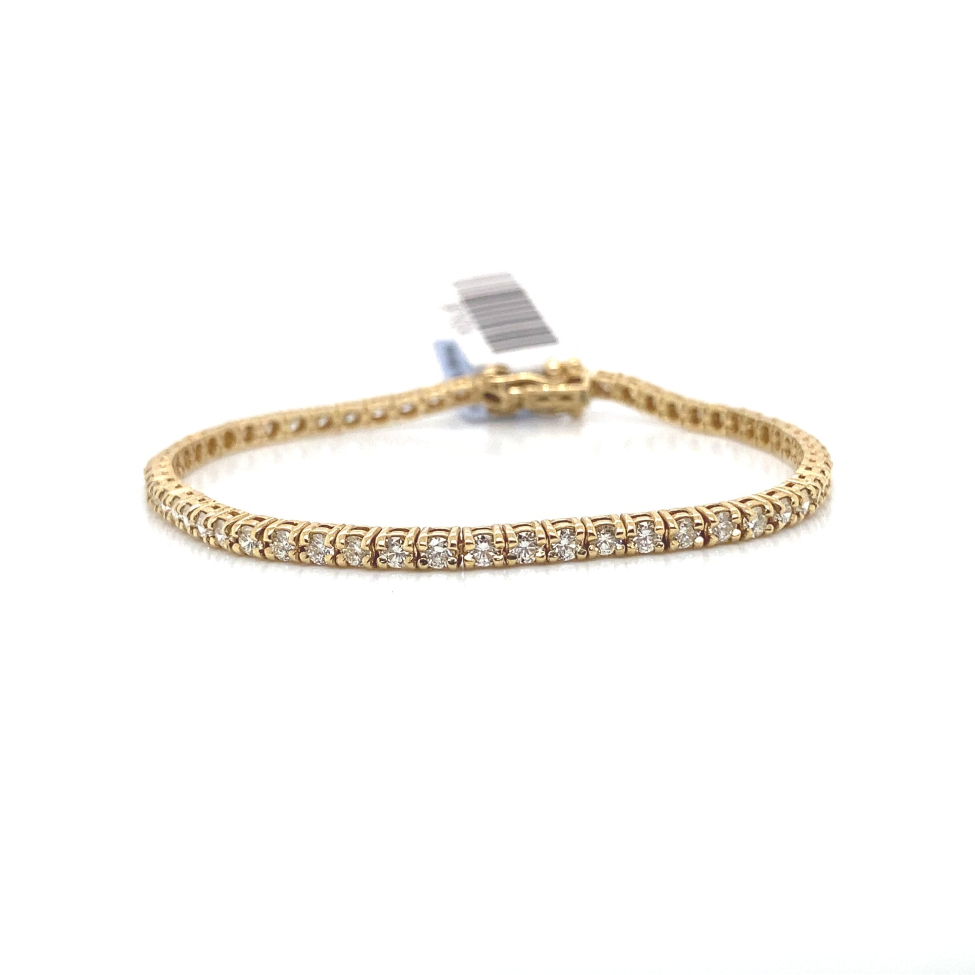 The 18K Rose Gold 1.03 ct TW Natural Round Brilliant Diamond Prong Set Bracelet, measuring 7 inches, is elegantly displayed on a reflective surface with its dazzling diamonds.