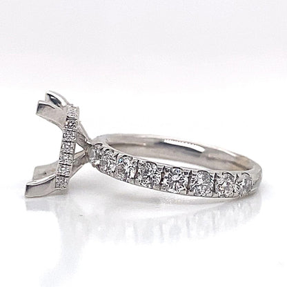 18k white gold ring with natural diamond accents along the band and an empty prong setting for a central stone, showcasing a hidden halo design, set against a white background.