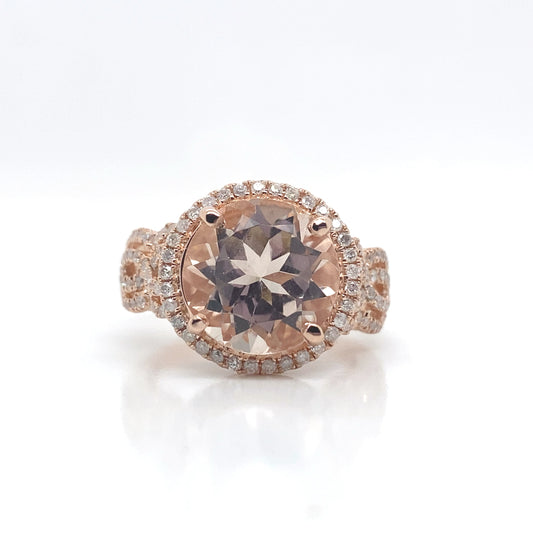 A 14K rose gold ring featuring a 4.20 ct round peach morganite and .62 ct diamond accents.