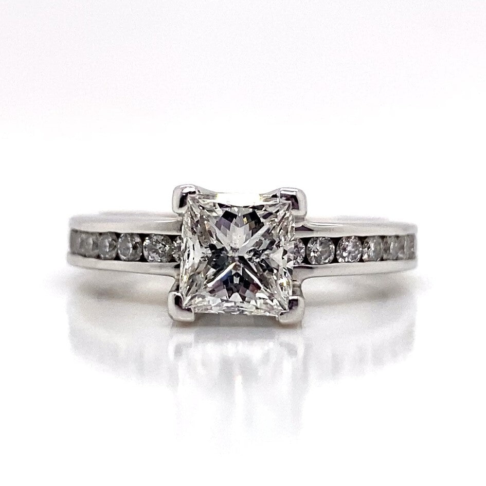 14K white gold ring showcasing a stunning 1.00 ct princess cut G/I1 natural diamond at its center, enhanced by a band adorned with 0.35 ctw delicate natural diamond accents on a pristine white setting.