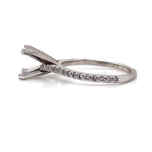 Side view of the 14K WHITE GOLD NO CENTER .26CT TW NATURAL ROUND BRILLIANT DIAMOND ACCENT FISHTAIL SET RING featuring diamond accents along the band and a prong setting for a stone.