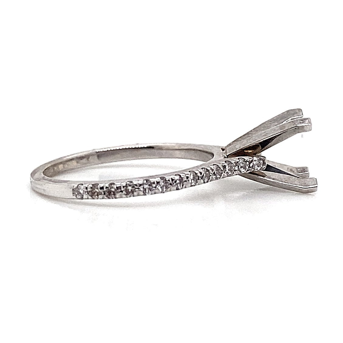 14K white gold ring featuring a fishtail setting and a band decorated with .26 carat total weight of natural round brilliant diamond accents on one side, adding an elegant touch that mimics the allure of natural diamond accents.