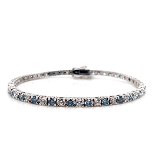 Chic 14K white gold tennis bracelet showcasing an alternating pattern of blue and white lab-grown diamonds set brilliantly against a white backdrop.