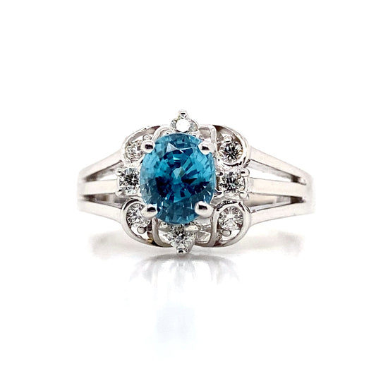 A 14K white gold ring showcasing a captivating 1.70 ct Blue Zircon at its center, beautifully surrounded by natural diamond accents totaling 0.208 tw.