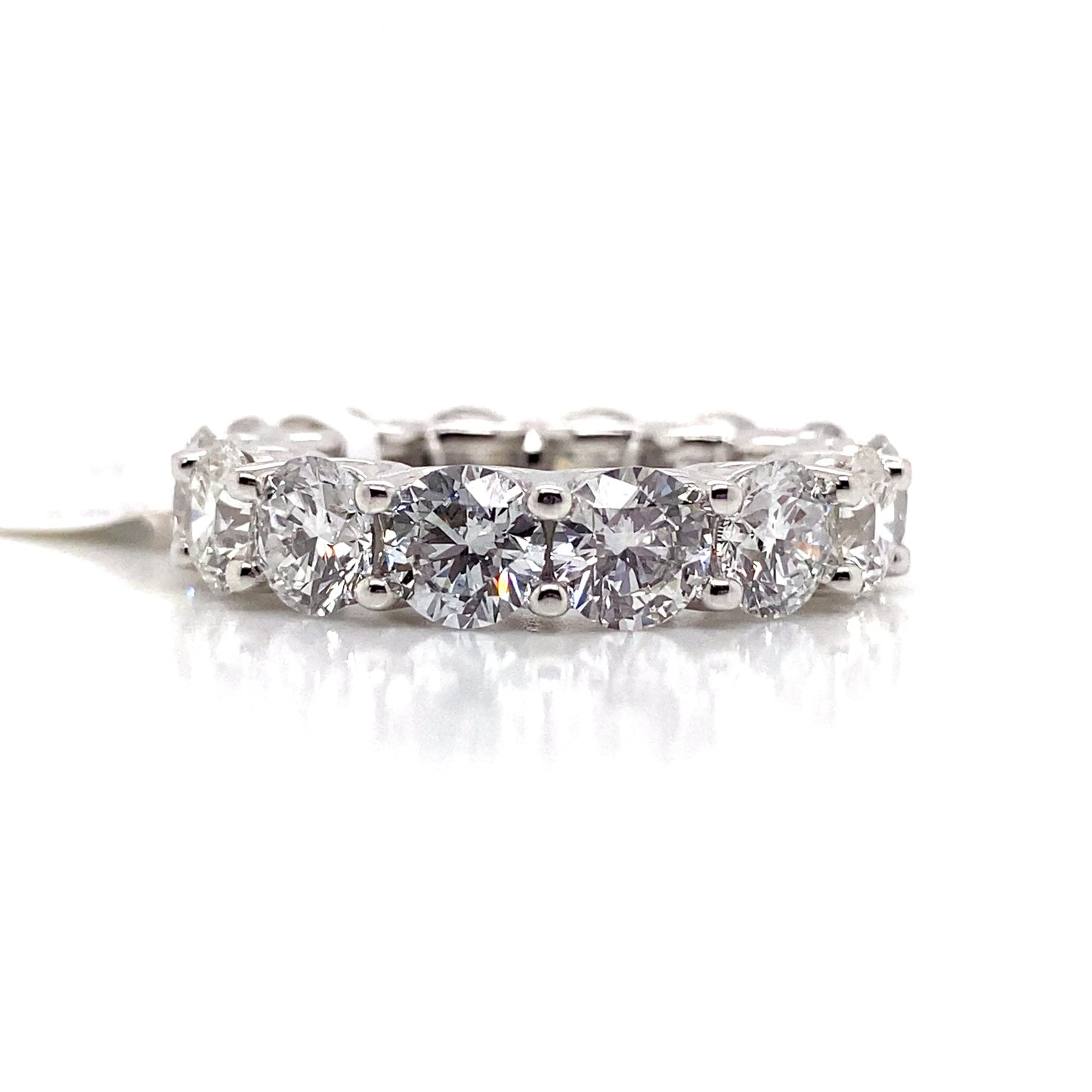 Introducing the 14K WHITE GOLD 8.28 CT TW LAB GROWN ROUND BRILLIANT DIAMOND ETERNITY BAND, an exquisite piece adorned with multiple dazzling round-cut lab-grown diamonds encircling the band, ideal for the eco-conscious jewelry enthusiast.