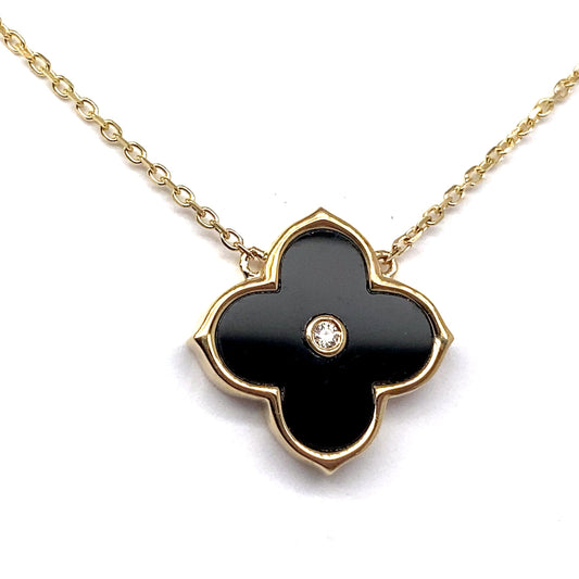 This elegant necklace in 14K white gold prominently features an inlay onyx center, complemented by .017 ct tw natural diamond accents for a touch of sophistication.