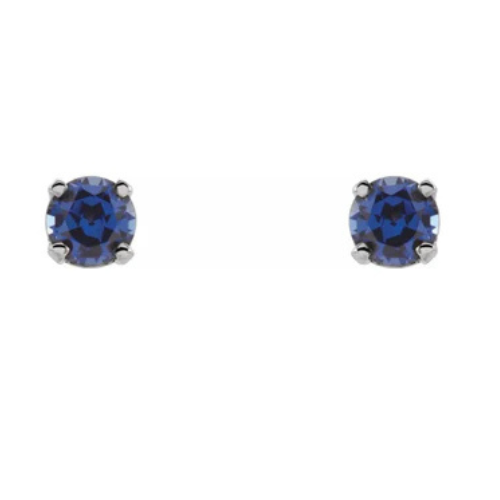 A pair of round, deep blue sapphire stud earrings, totaling .40 carats and set in a 14K white gold prong setting, is displayed on a pristine white background.