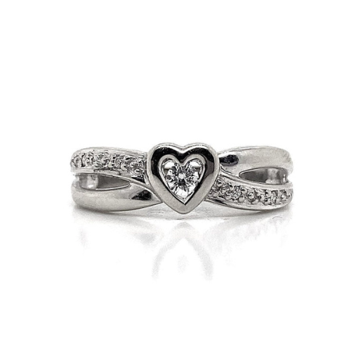 Discover the sophistication of the 10K White Gold .12 CT TW Design Fashion Ring, showcasing a heart-shaped center embraced by a criss-cross design with small diamonds on a twisted band. This stunning piece is crafted to captivate hearts and enhance your collection with timeless beauty.