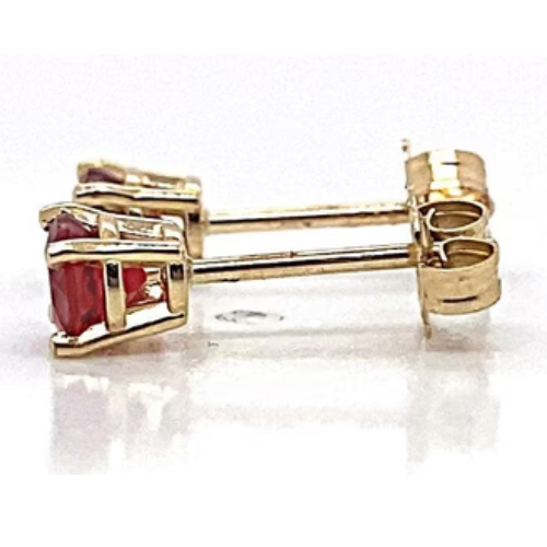 The 14K yellow gold .60 CT TW natural ruby round brilliant AA quality stud earrings are elegantly displayed on a white surface.