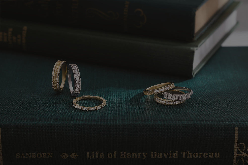 Gold rings on a stack of books with a dark background
