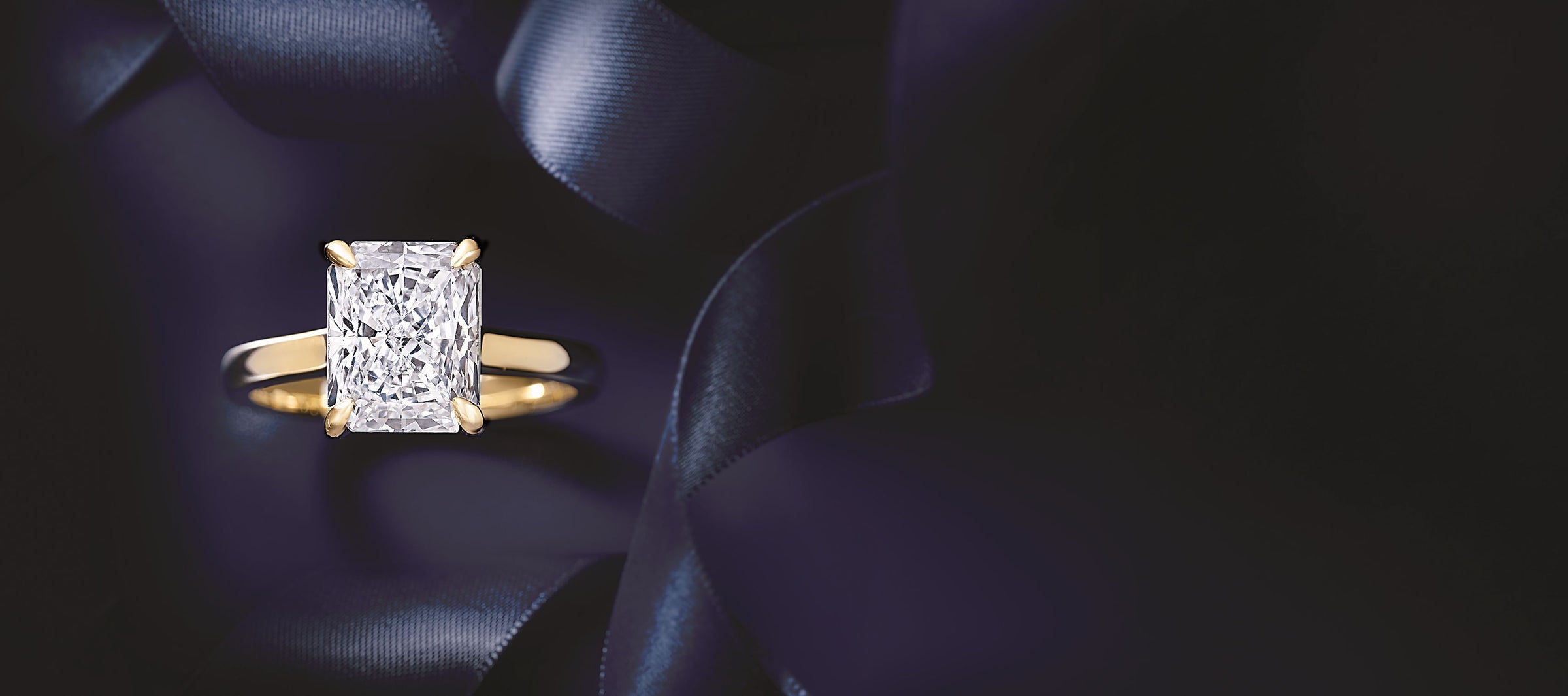 Diamond ring on a dark blue satin background