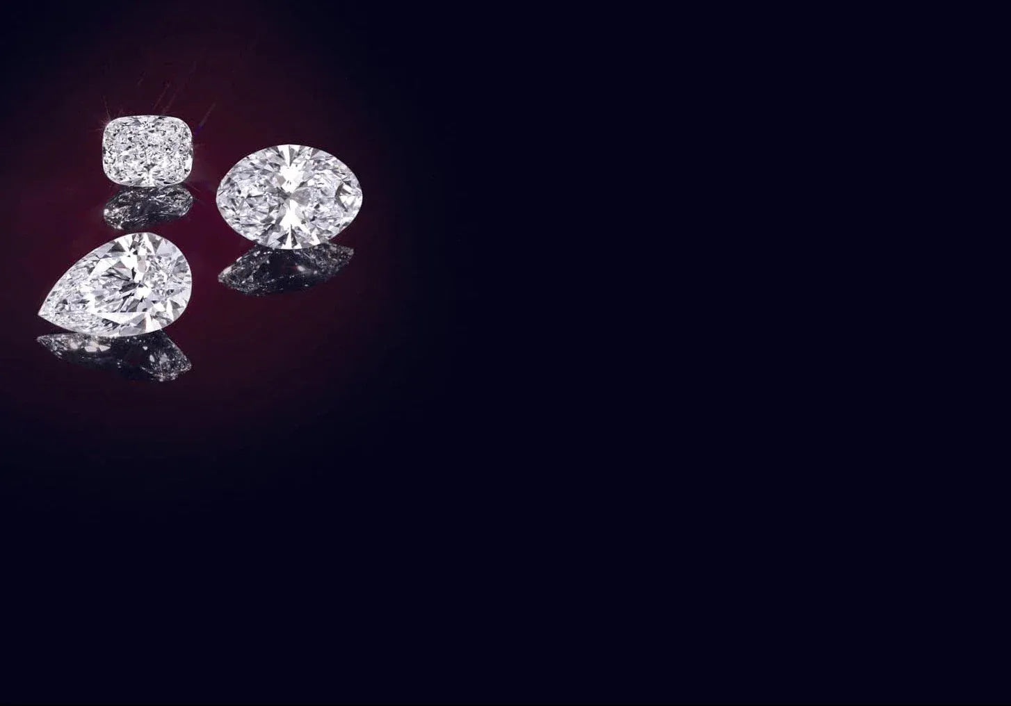 Three loose lab grown diamonds on a black background