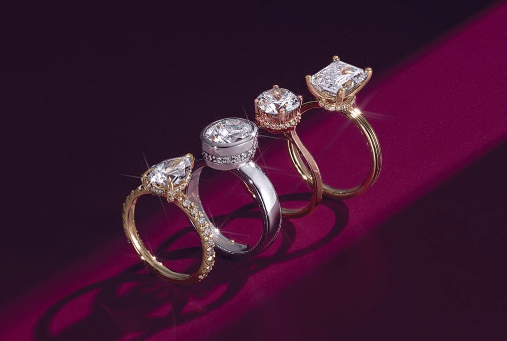Four diamond rings on a dark red background