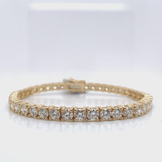 18K YELLOW  9.30 CT TW NATURAL ROUND BRILLIANT DIAMOND  F-G/VVS-VS  7" LENGTH  PRONG SET TENNIS BRACELET