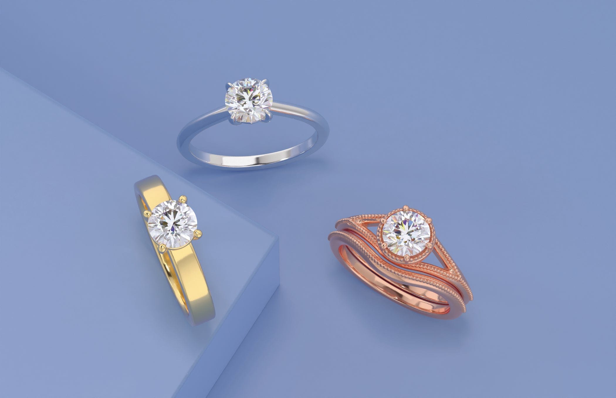 Three diamond engagement rings in gold, silver, and rose gold on a blue background