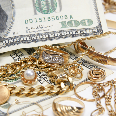 Sell Your Jewelry products, adorned with shimmering gemstones, are elegantly displayed over crisp hundred-dollar bills.